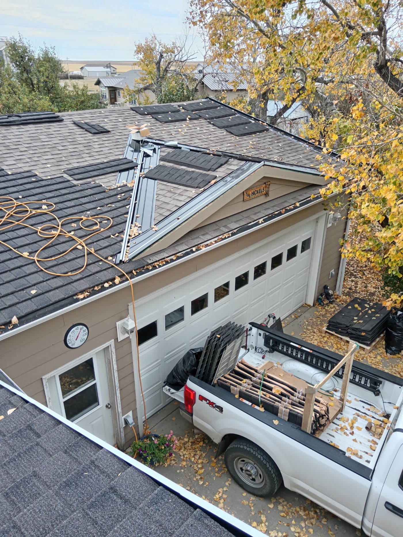 WeatherLok steel panels being installed over an existing asphalt roof