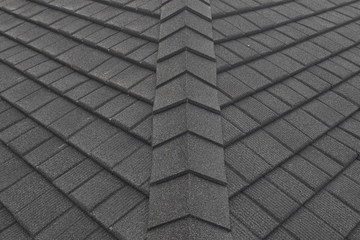 A WeatherLok Slate Shingle roof, stone-coated steel courses meeting along the hip ridge